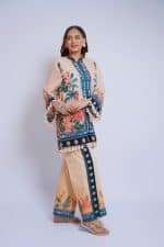 Woman wearing a colorful embroidered ethnic dress with floral and geometric patterns.