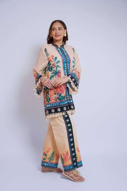 Woman wearing a colorful embroidered ethnic dress with floral and geometric patterns.