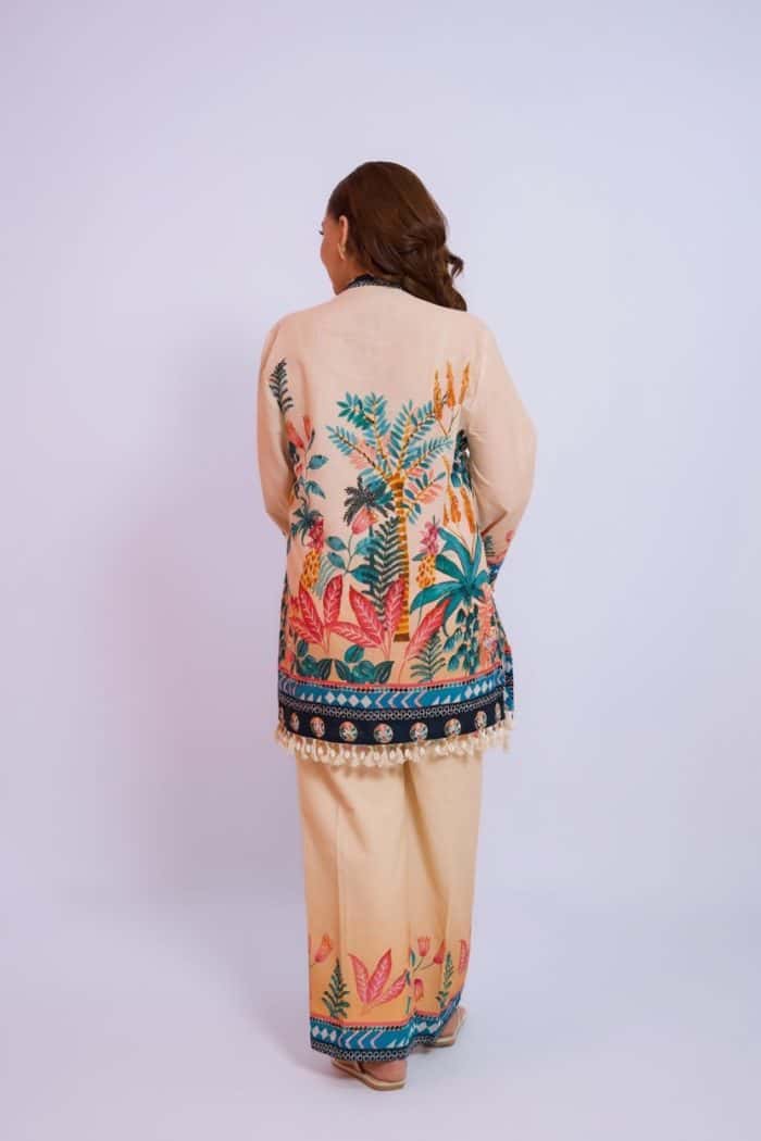 Woman wearing a colorful, handwoven Indian saree with intricate floral patterns and traditional moti.